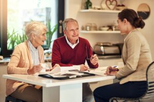 Older Homeowners Discussing Reverse Mortgage Options With A Lender